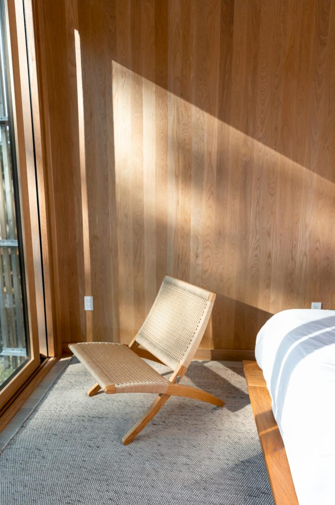 Chair at foot of bed in sunshine